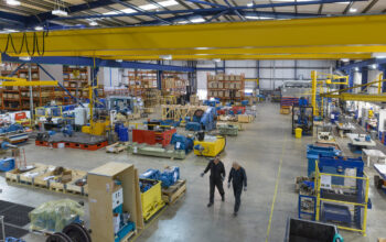 High angle view of workers in engineering factory High angle view of workers in engineering factory