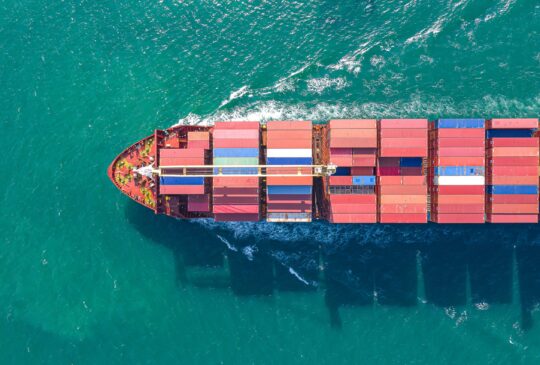 Aerial top view of cargo ship carrying container for import export goods  to customer,concept logistic and supply chain.