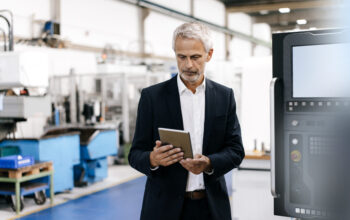 Manager using digital tablet in high tech company
