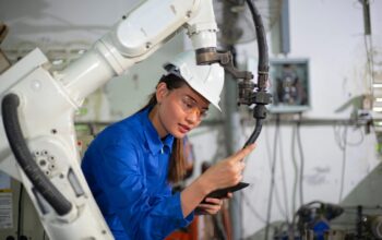 Engineer check and control welding robotics automatic arms machine in intelligent factory industrial.
